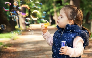 Child blowing bubbles